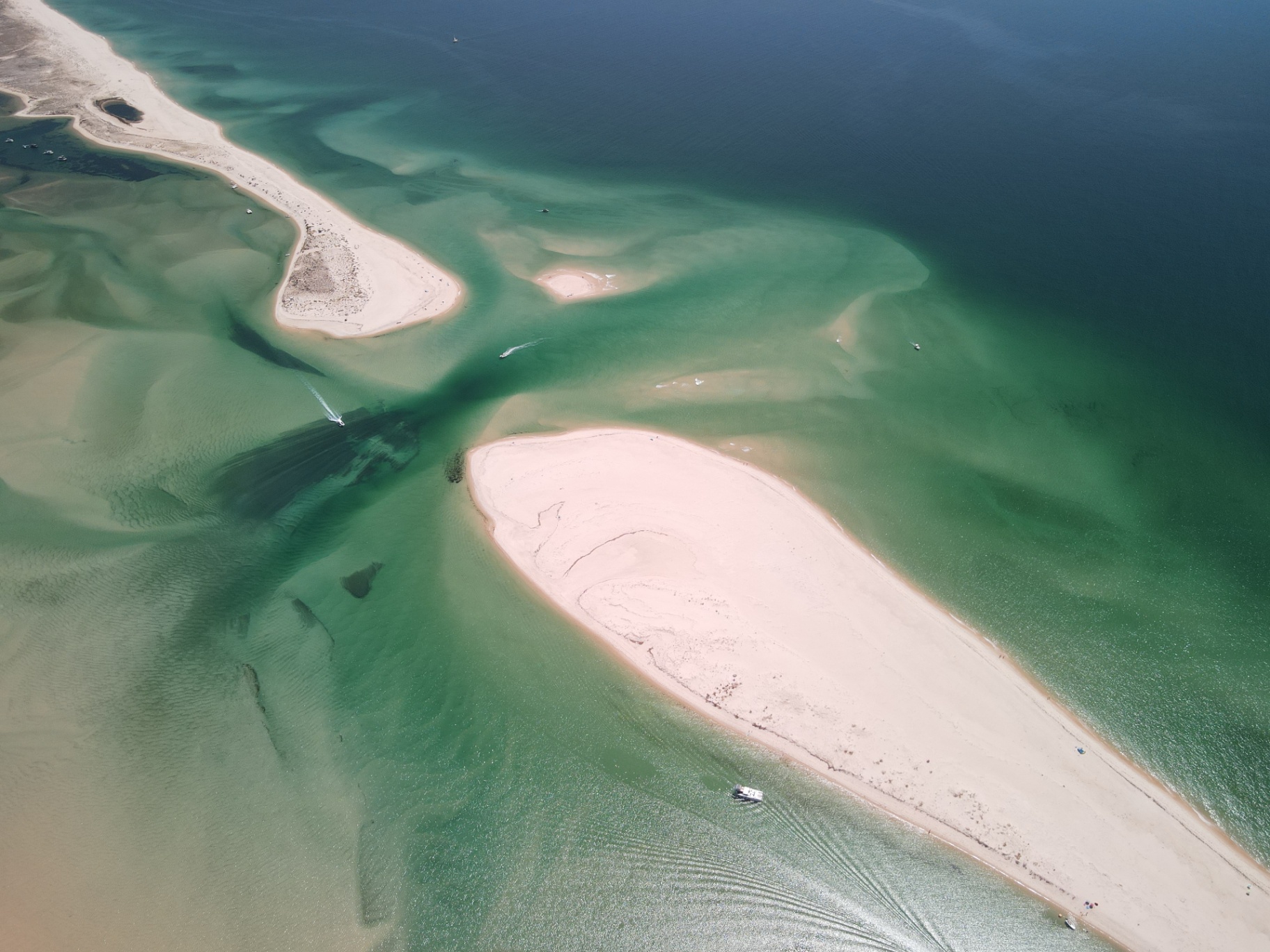 Aerial view of white sandbanks in turquoise Ria Formosa waters